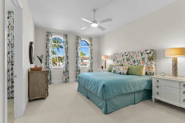 a bedroom with a large bed and a chandelier