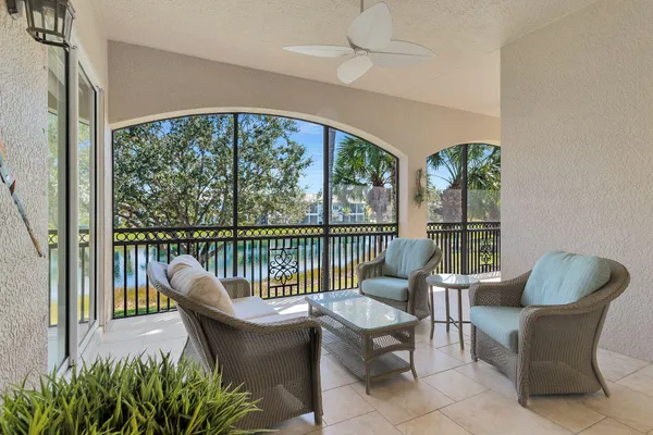 a balcony with furniture and wooden floor