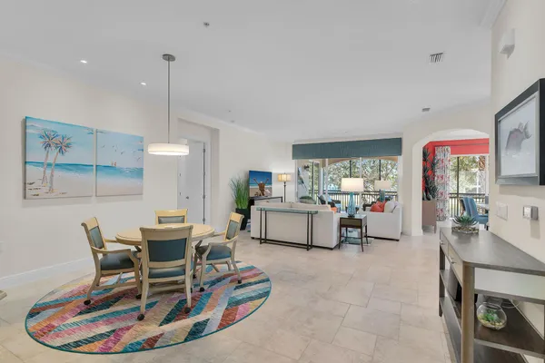 a living room with furniture and kitchen view