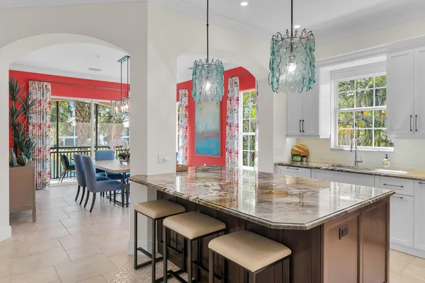 a kitchen with a sink a counter and chairs