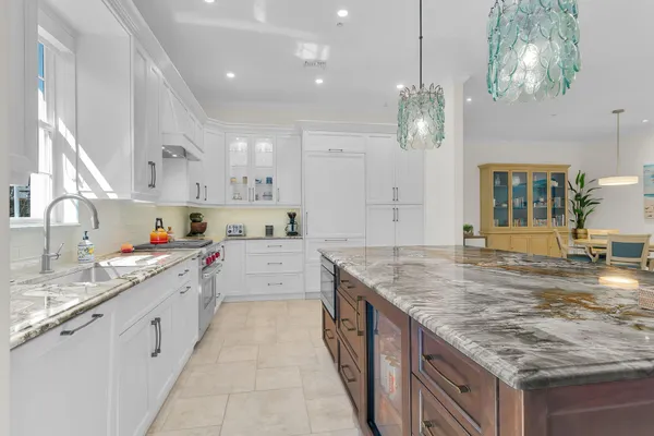 a kitchen with kitchen island granite countertop a sink counter top space and cabinets