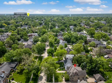 an aerial view of a houses with a yard
