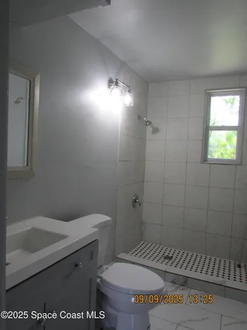 a bathroom with a toilet and a sink