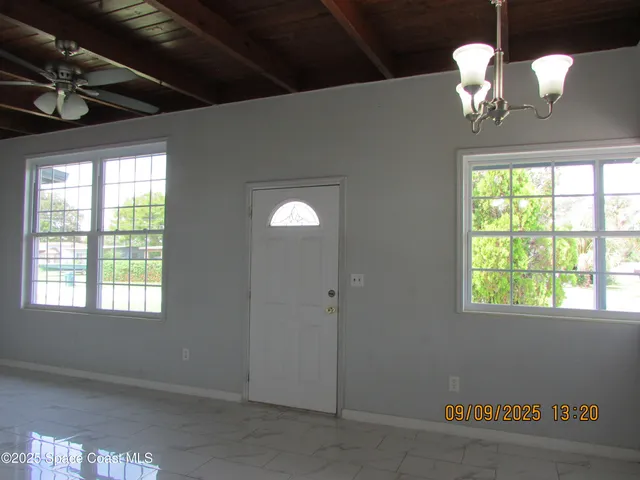 a view of a dining room with a chandelier