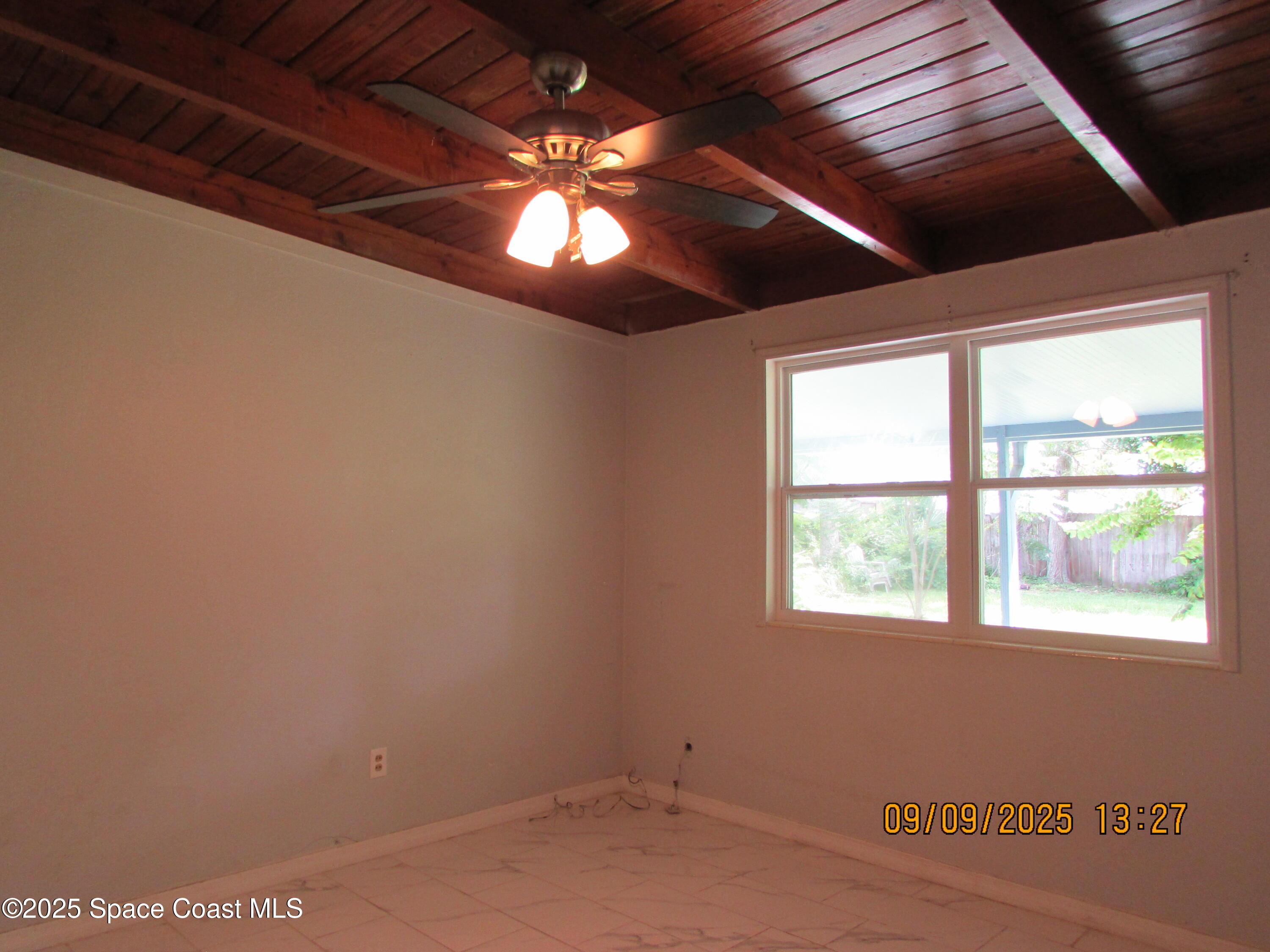 1647 Dixie Way Melbourne, FL 32935 - Photo 8 of 15 an empty room with a ceiling fan and window