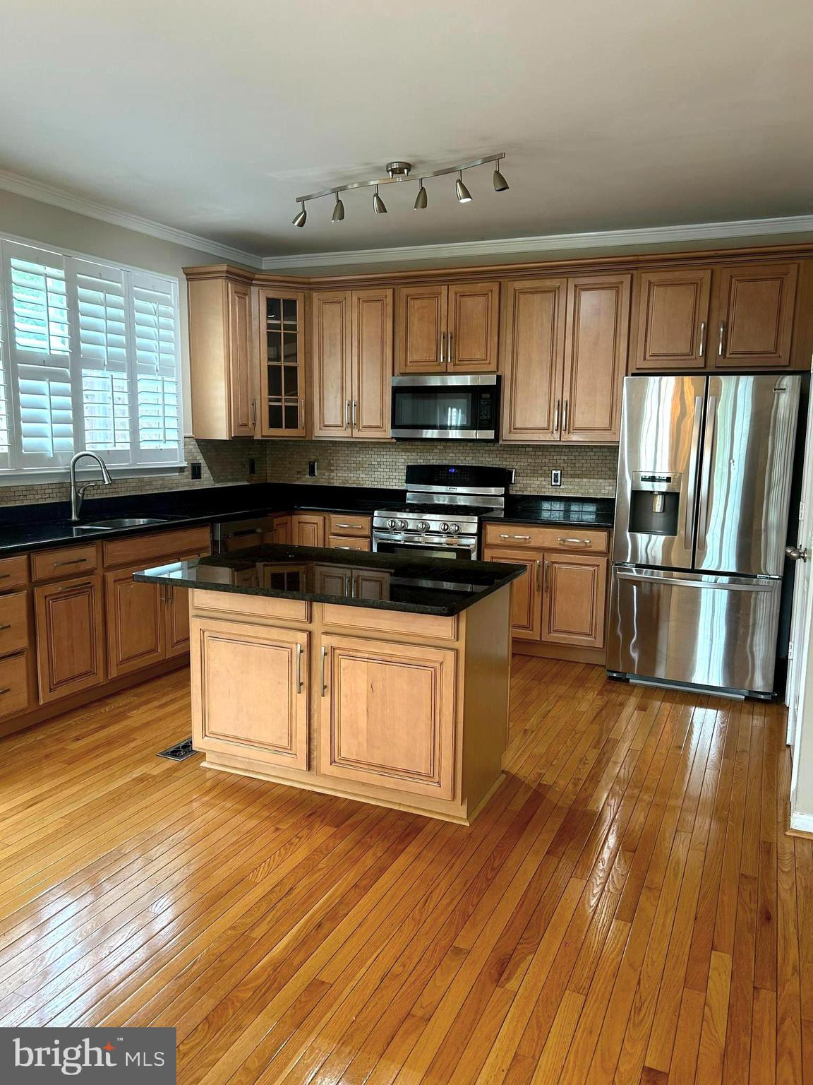 4658 Buckhorn Ridge Fairfax, VA 22030 - Photo 6 of 35 a kitchen with stainless steel appliances granite countertop a stove a sink and a microwave