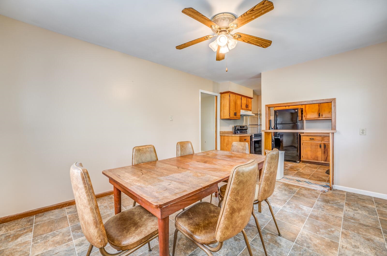 6125 Warren Road Oakland, TN 38060 - Photo 13 of 40 Dining area featuring a ceiling fan with light fixture, neutral wall paint, and tiled flooring