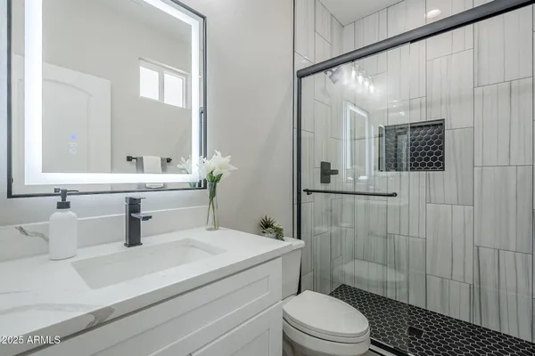 a bathroom with a shower and a sink