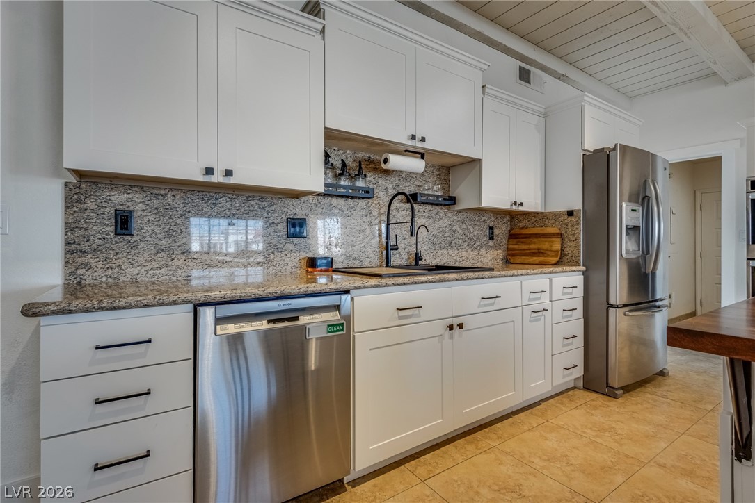 524 Swallow Cove Boulder City, NV 89005 - Photo 13 of 58 A well-appointed kitchen showcasing contemporary cabinetry and durable granite countertops.