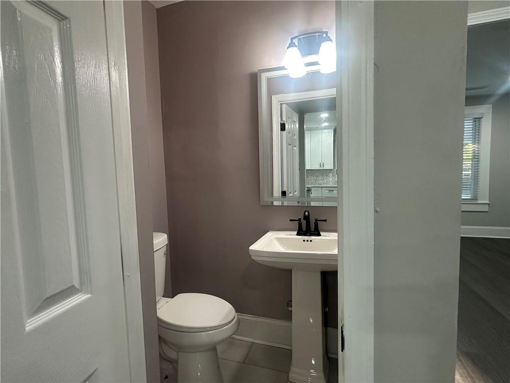 2300 Dauphine Street Atlanta, GA 30344 - Photo 17 of 34 a bathroom with a toilet sink and mirror