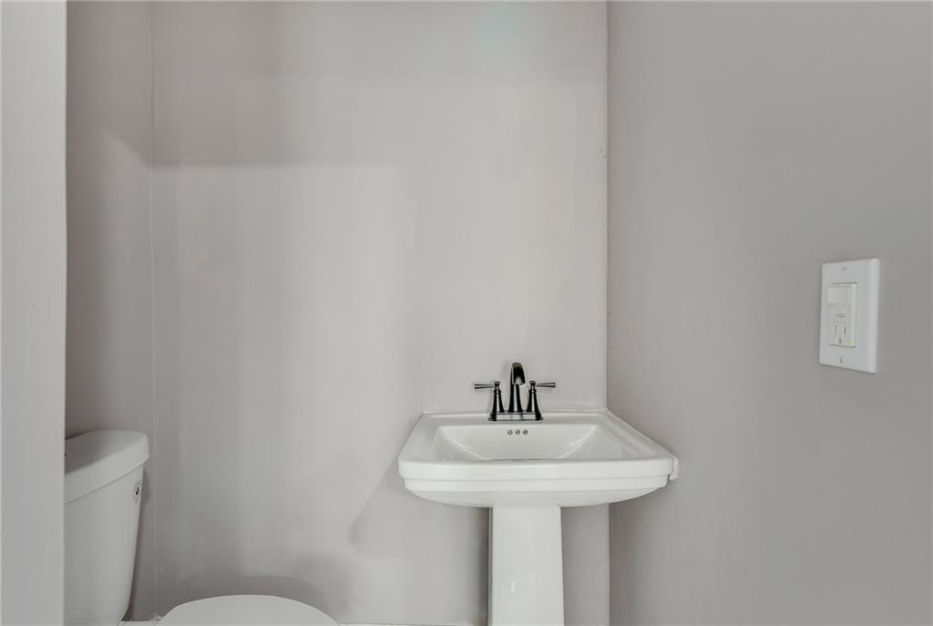 2300 Dauphine Street Atlanta, GA 30344 - Photo 18 of 34 a bathroom with a sink a mirror and toilet