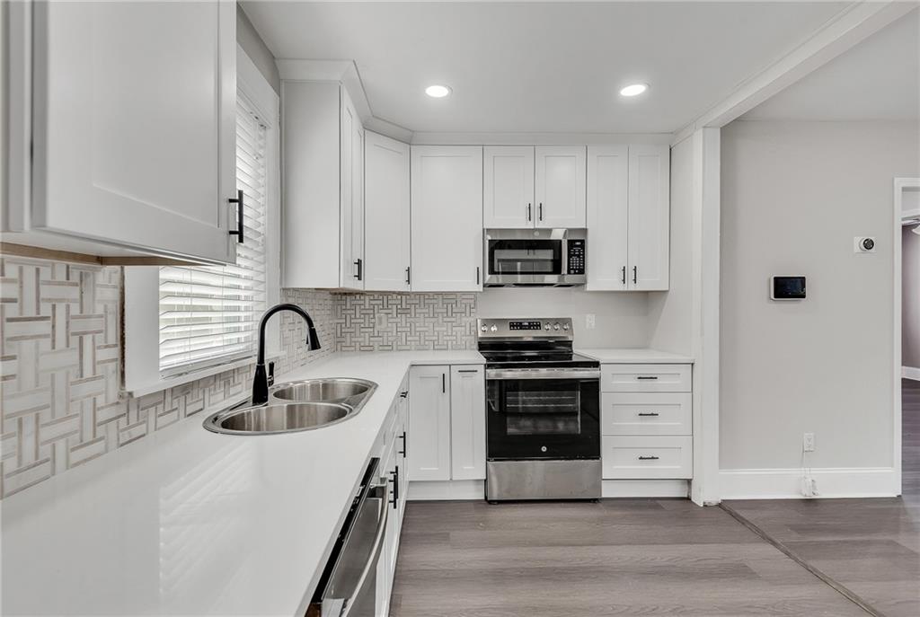 2300 Dauphine Street Atlanta, GA 30344 - Photo 20 of 34 a kitchen with stainless steel appliances a stove sink and cabinets