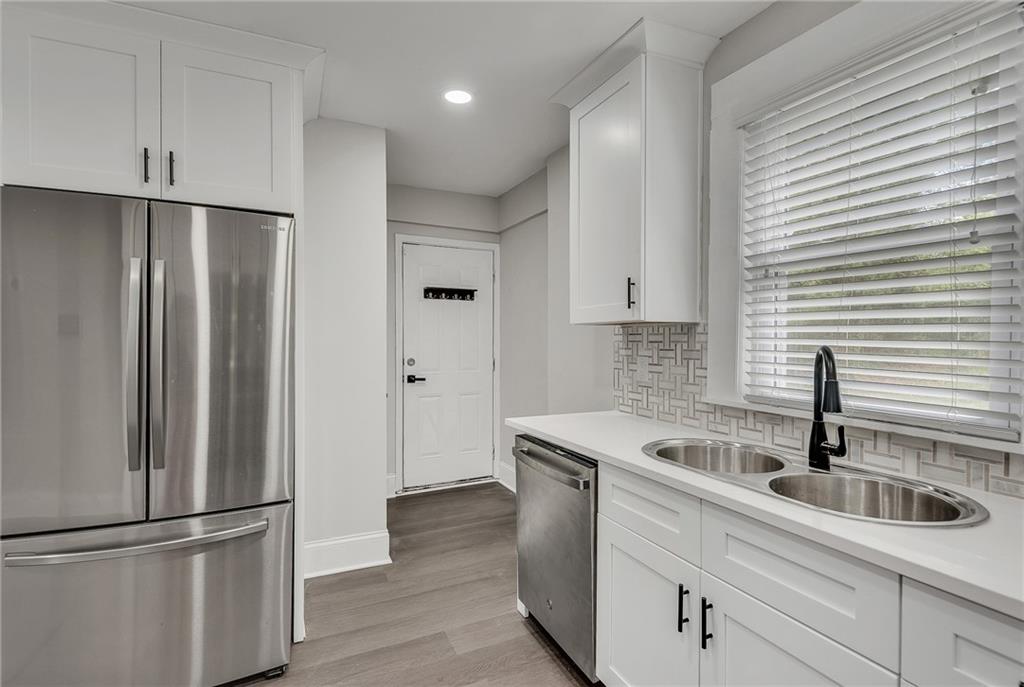 2300 Dauphine Street Atlanta, GA 30344 - Photo 22 of 34 a kitchen with stainless steel appliances granite countertop white refrigerator a sink and white cabinets
