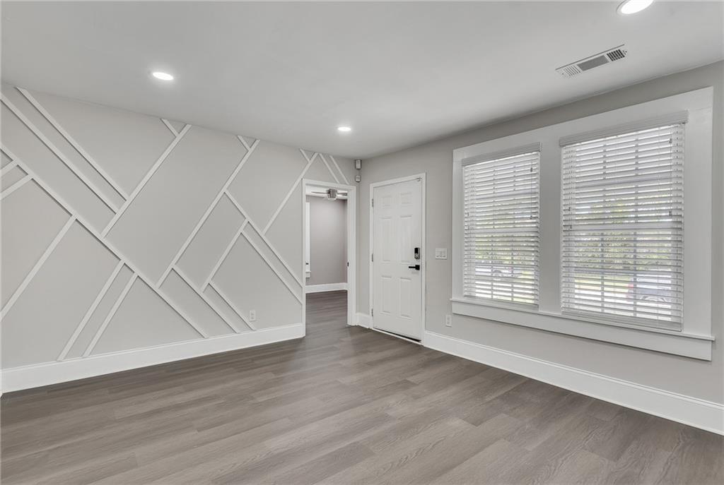 2300 Dauphine Street Atlanta, GA 30344 - Photo 5 of 34 a view of an empty room with wooden floor and a window