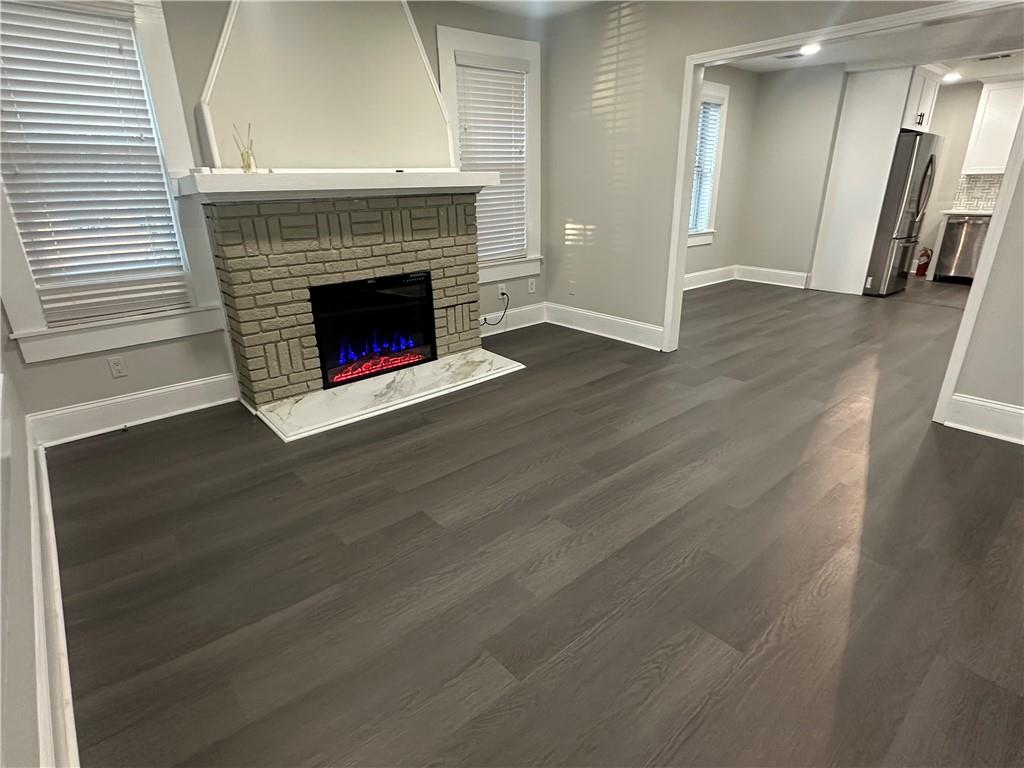 2300 Dauphine Street Atlanta, GA 30344 - Photo 6 of 34 a view of a hallway with wooden floor and a fireplace