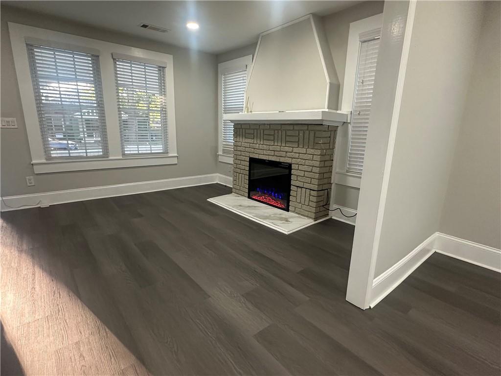 2300 Dauphine Street Atlanta, GA 30344 - Photo 7 of 34 a view of an empty room with wooden floor fireplace and a window