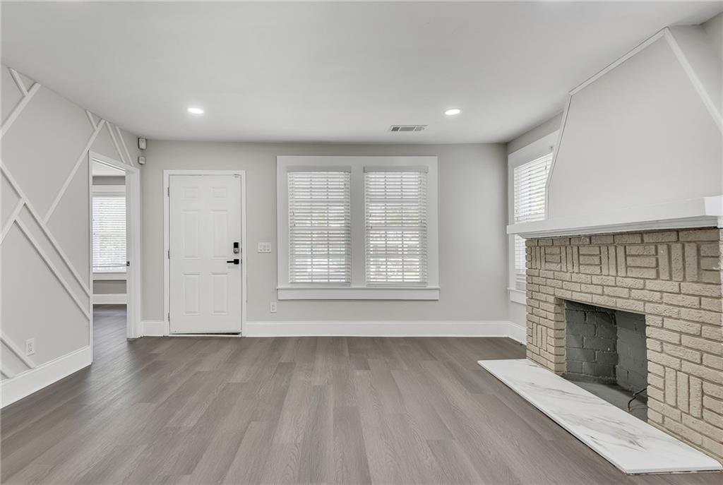 2300 Dauphine Street Atlanta, GA 30344 - Photo 9 of 34 a view of empty room with wooden floor and fireplace