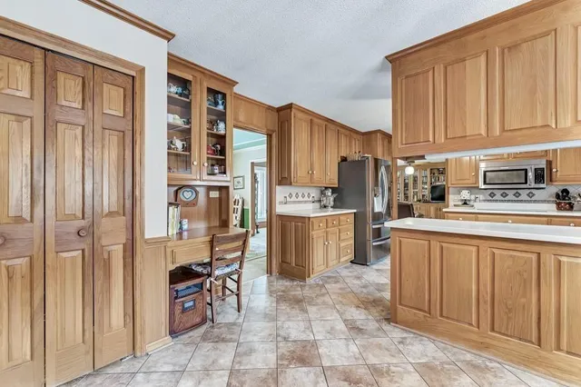 a kitchen with stainless steel appliances a refrigerator and cabinets