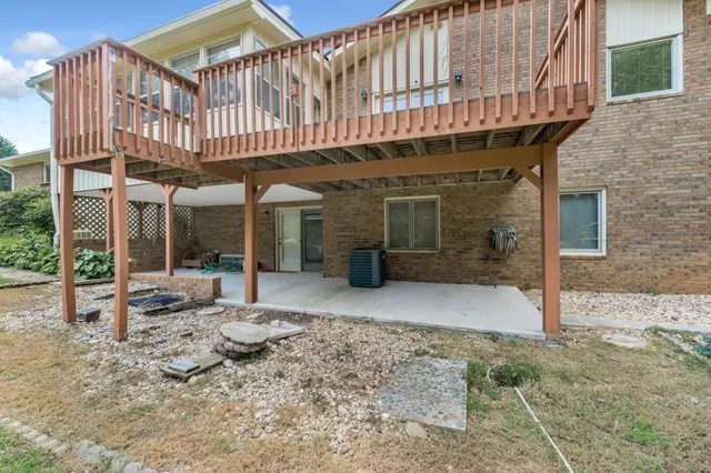 a backyard of a house with barbeque oven table and chairs