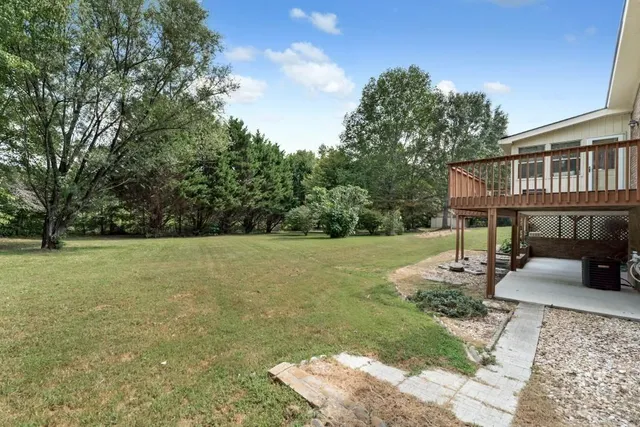 a view of a house with backyard porch and sitting area