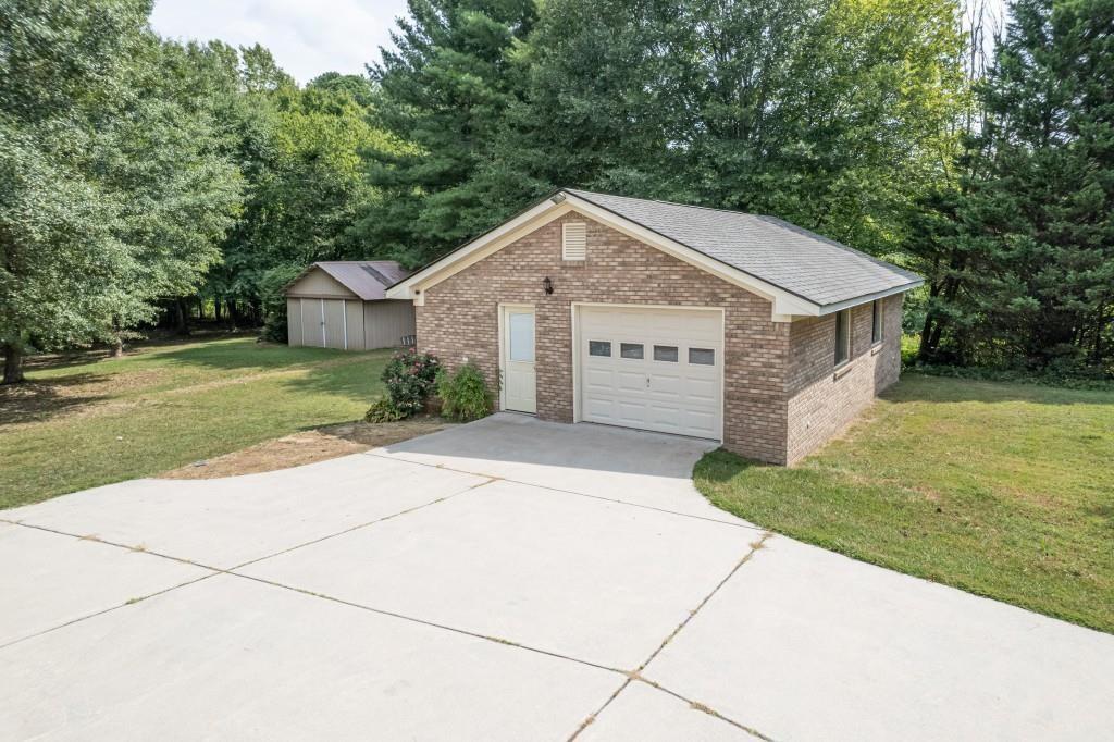 4640 Spot Road Cumming, GA 30040 - Photo 4 of 28 a view of a house with a yard and large tree