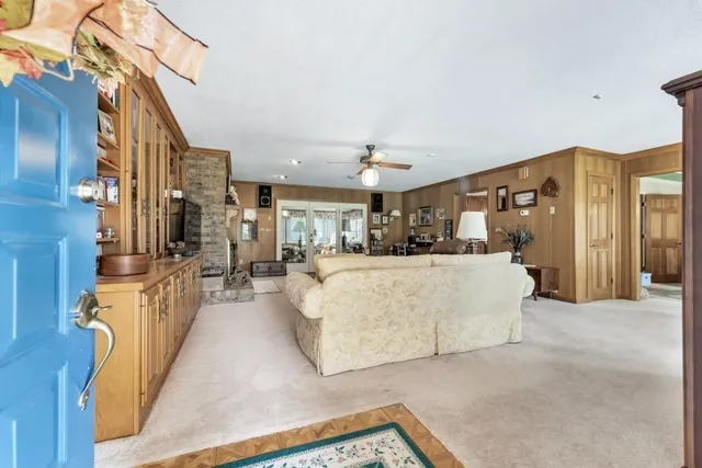 a living room with furniture and a chandelier