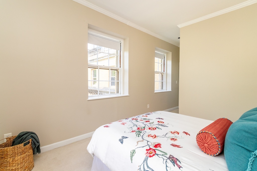 60e Glen Road, Unit 306 Brookline, MA 02445 - Photo 20 of 27 a bedroom with a bed and a window