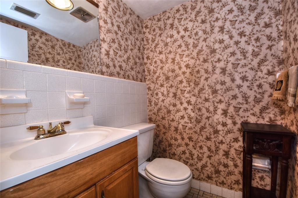 1951 Northeast 39th Street, Unit 360 Lighthouse Point, FL 33064 - Photo 11 of 28 a bathroom with a sink a toilet and mirror