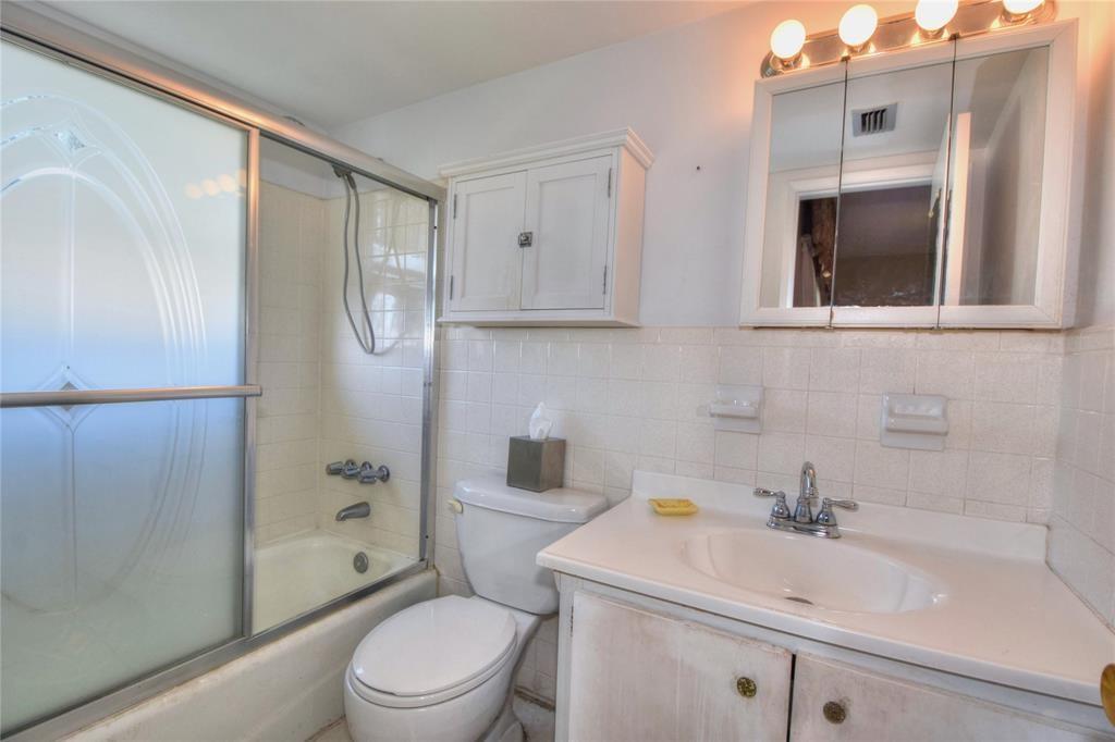 1951 Northeast 39th Street, Unit 360 Lighthouse Point, FL 33064 - Photo 17 of 28 a bathroom with a sink a toilet and shower