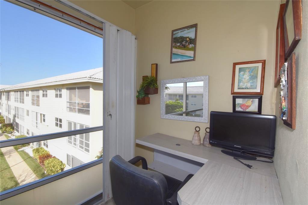 1951 Northeast 39th Street, Unit 360 Lighthouse Point, FL 33064 - Photo 19 of 28 a living room with furniture and a window