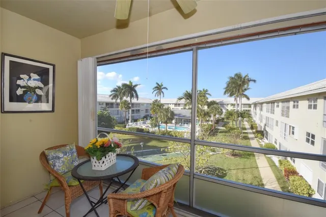 a view of a house with swimming pool and sitting area