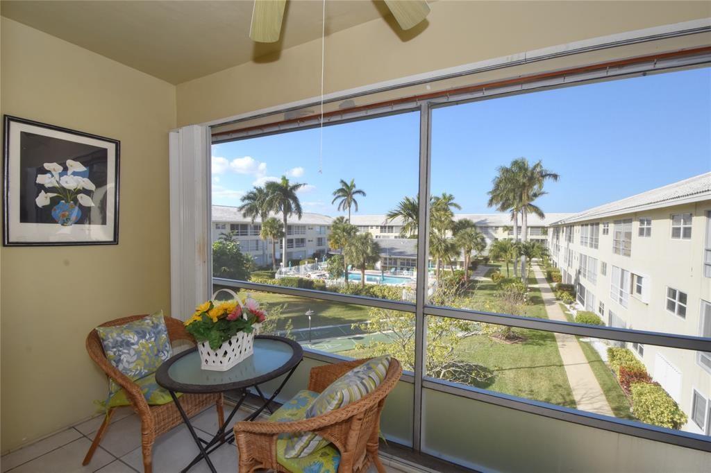 1951 Northeast 39th Street, Unit 360 Lighthouse Point, FL 33064 - Photo 20 of 28 a view of a dining room with furniture a chandelier and wooden floor