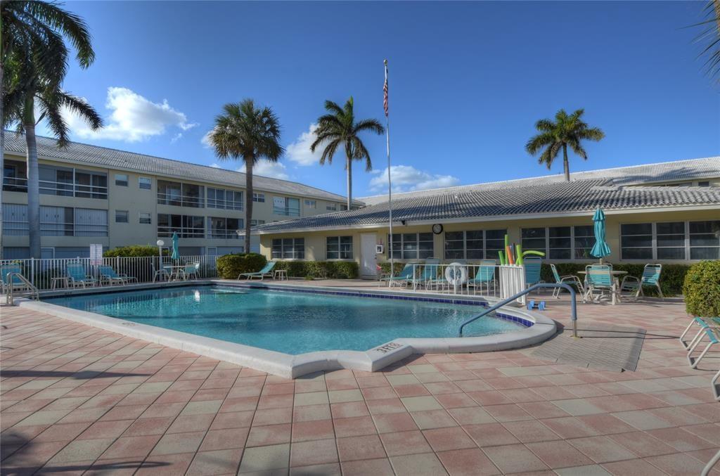 1951 Northeast 39th Street, Unit 360 Lighthouse Point, FL 33064 - Photo 22 of 28 a view of a house with swimming pool and sitting area