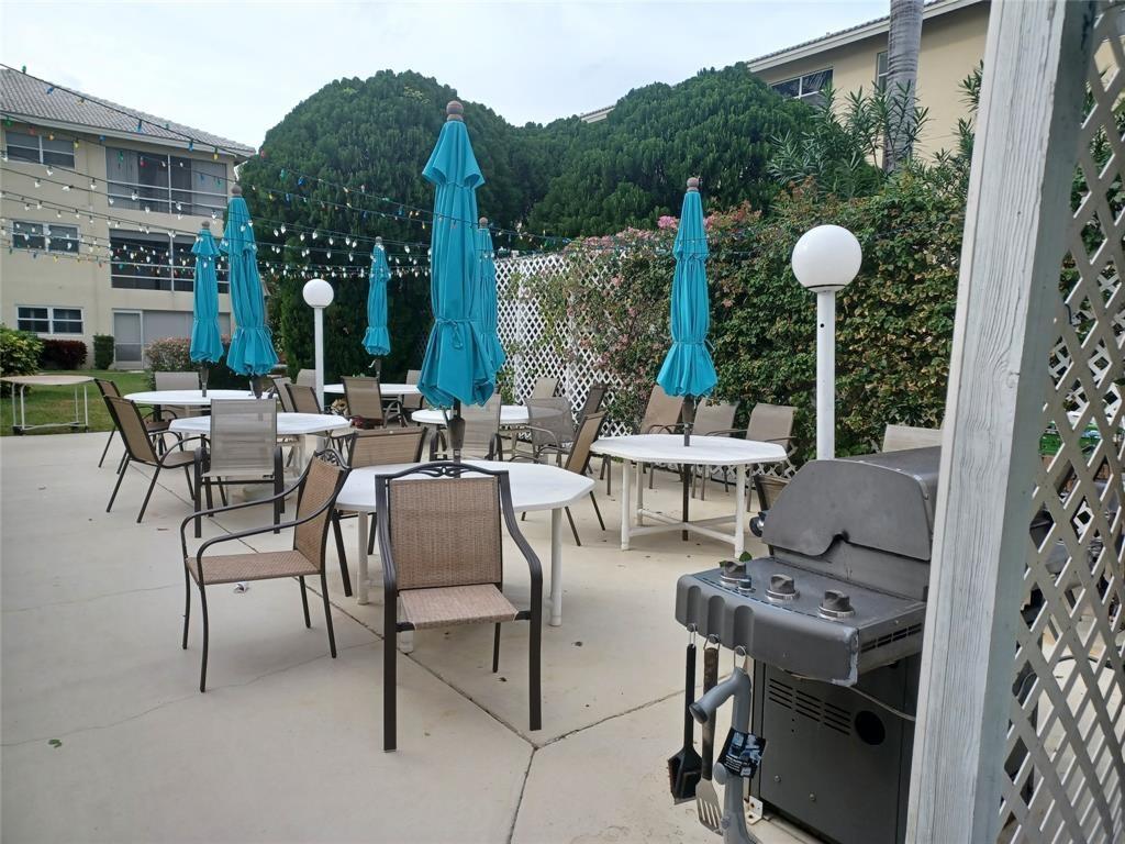 1951 Northeast 39th Street, Unit 360 Lighthouse Point, FL 33064 - Photo 24 of 28 a view of an chairs and tables in patio