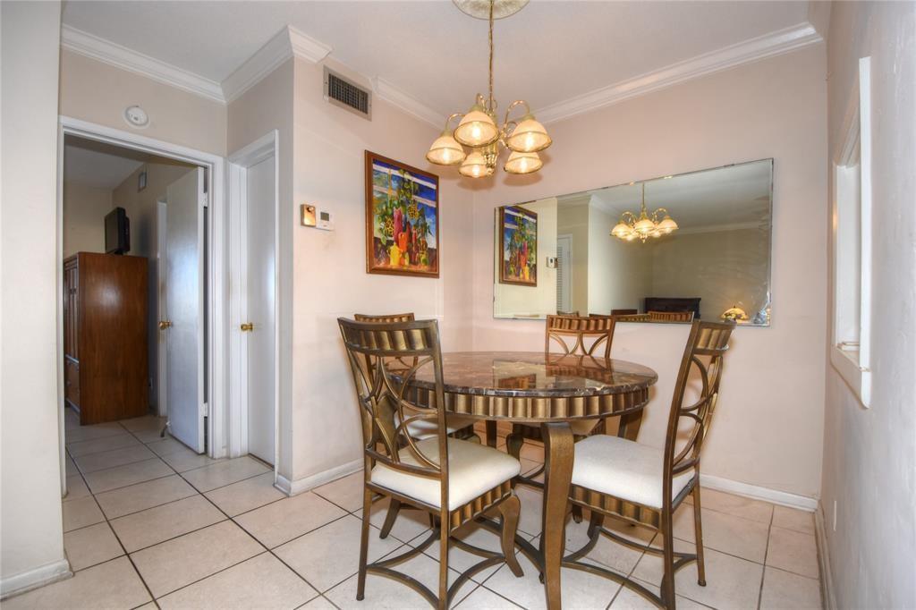 1951 Northeast 39th Street, Unit 360 Lighthouse Point, FL 33064 - Photo 8 of 28 a view of a dining room with furniture and chandelier