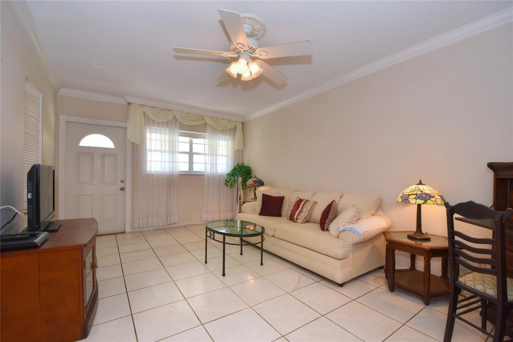 1951 Northeast 39th Street, Unit 360 Lighthouse Point, FL 33064 - Photo 9 of 28 a living room with furniture and a flat screen tv