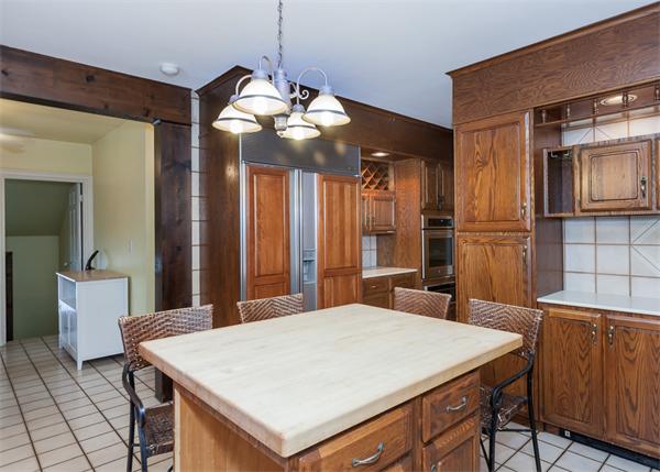 368 Longhill Street Springfield, MA 01108 - Photo 13 of 30 a large kitchen with a table chairs and a refrigerator