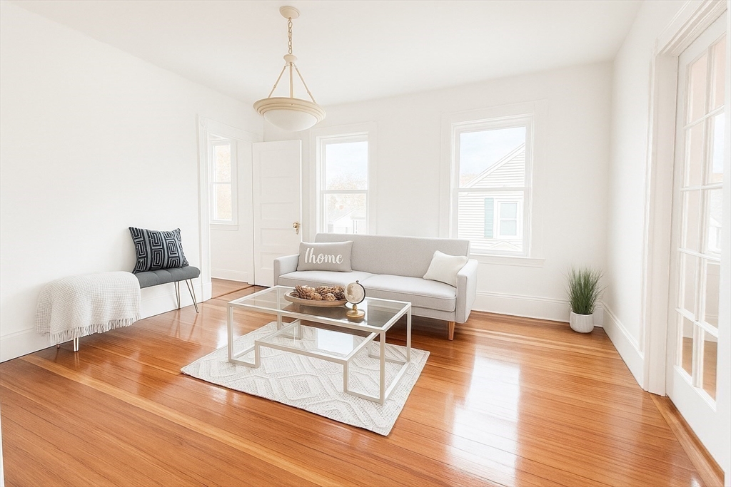 145 Lagrange Street Boston, MA 02132 - Photo 16 of 37 a living room with furniture and a wooden floor
