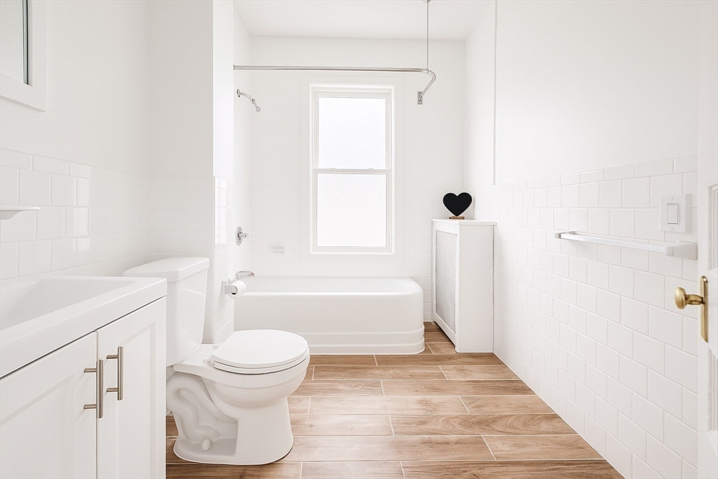 145 Lagrange Street Boston, MA 02132 - Photo 19 of 37 a bathroom with a toilet a sink and a bathtub
