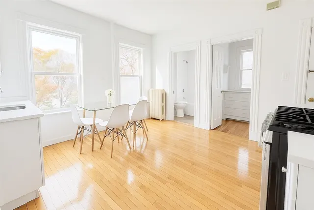 a view of a dining room with furniture and a window