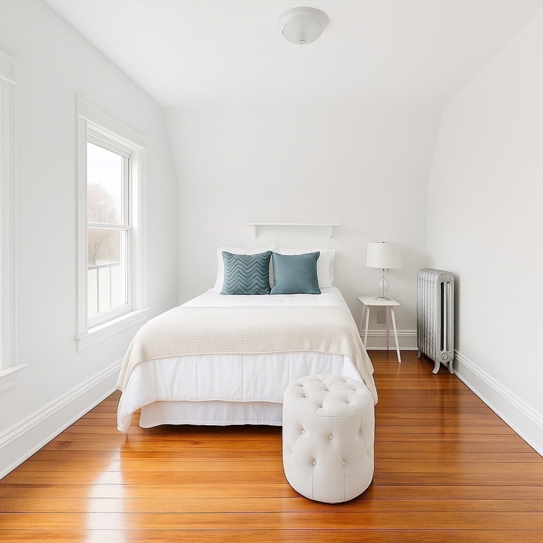 145 Lagrange Street Boston, MA 02132 - Photo 25 of 37 a bedroom with a bed and wooden floor