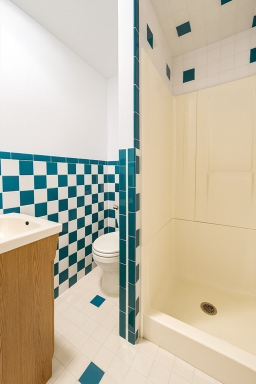 145 Lagrange Street Boston, MA 02132 - Photo 28 of 37 a bathroom with a bathtub and a shower