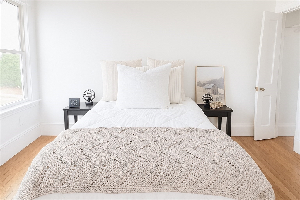 145 Lagrange Street Boston, MA 02132 - Photo 10 of 37 a bed sitting in a bedroom and a large window