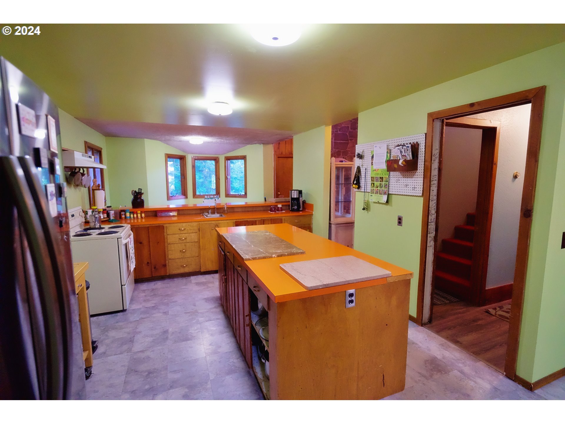 277 Trout Lake Creek Road Trout Lake, WA 98650 - Photo 17 of 35 a kitchen that has a lot of cabinets a sink and a refrigerator