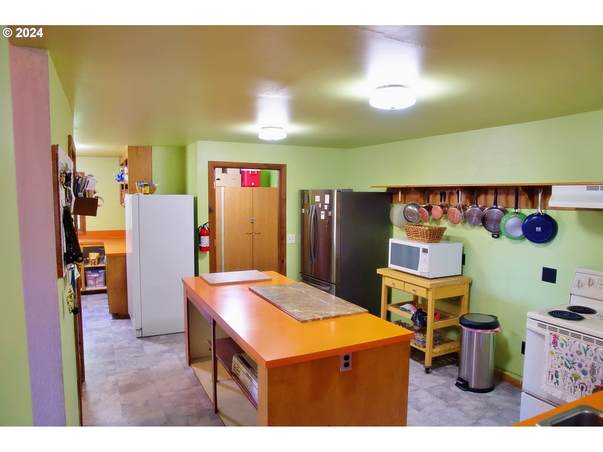 277 Trout Lake Creek Road Trout Lake, WA 98650 - Photo 19 of 35 a kitchen that has a lot of cabinets and refrigerator