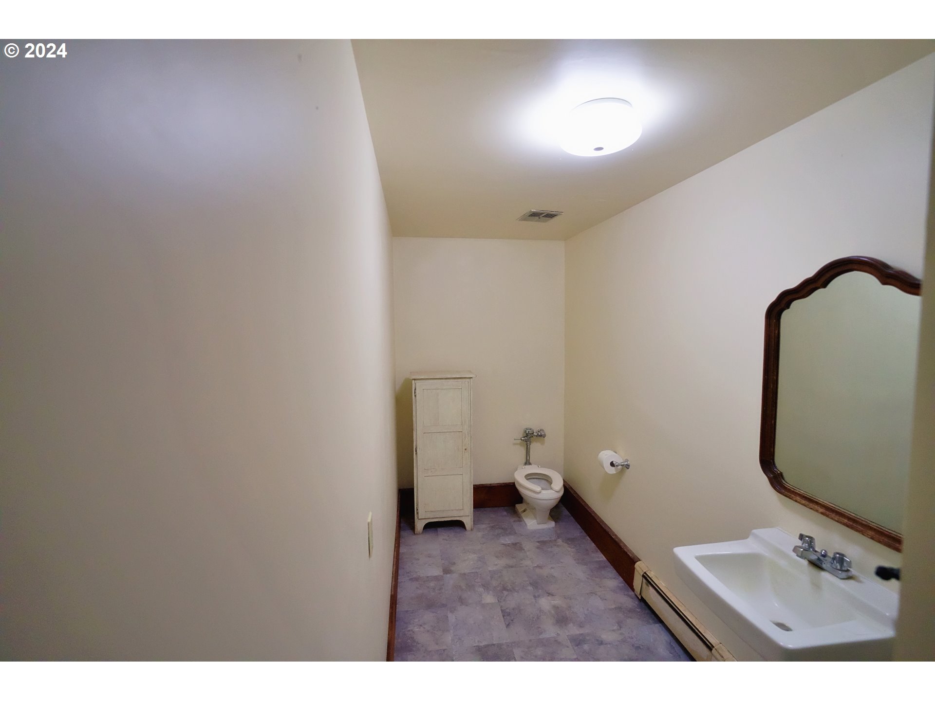 277 Trout Lake Creek Road Trout Lake, WA 98650 - Photo 25 of 35 a bathroom with a toilet sink and mirror