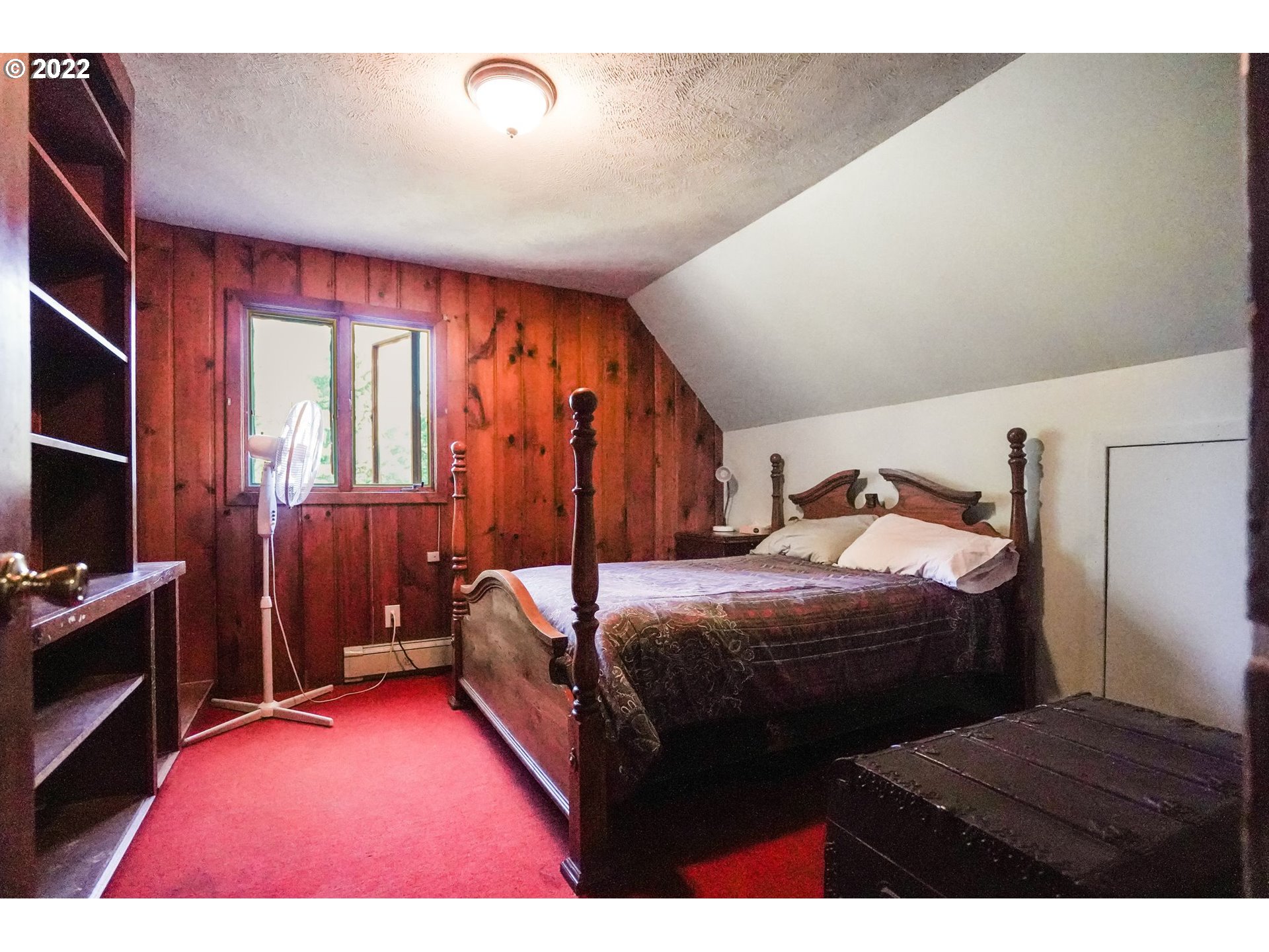 277 Trout Lake Creek Road Trout Lake, WA 98650 - Photo 30 of 35 a bedroom with a bed next to a window with dresser