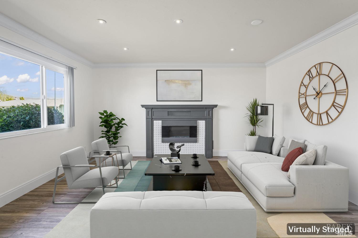 a living room with furniture a fireplace and a large window