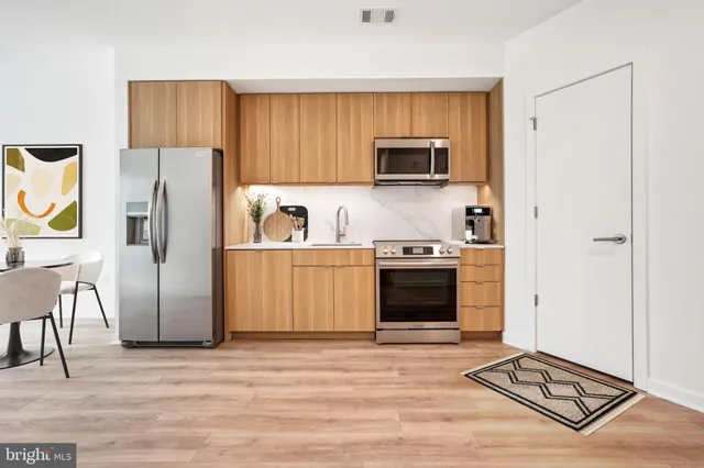a kitchen with stainless steel appliances a stove a microwave and a refrigerator