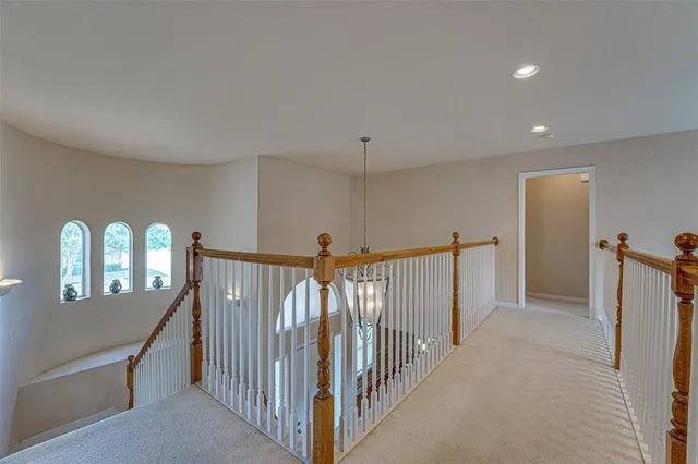 a view of a hallway with entryway and stairs